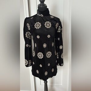 Black velvet dress with white embroidered detail
